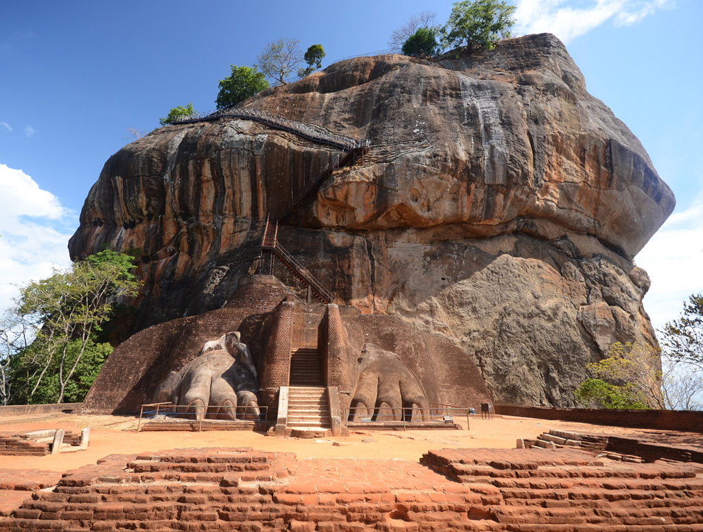 Sigiriya rock climbing experience - spiral staircase hugging the cliff face leading to ancient frescoes of celestial maidens