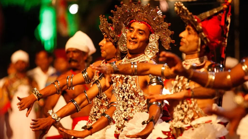 Kandy cultural show and dinner - Kandyan dancer in full silver costume and traditional headdress performing Ves dance