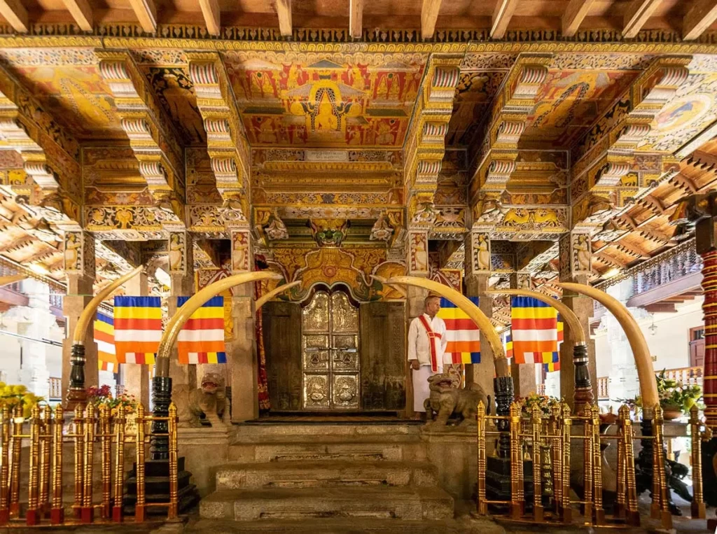 Temple of the Sacred Tooth Relic tour - golden casket shrine interior with devotees offering flowers and oil lamps