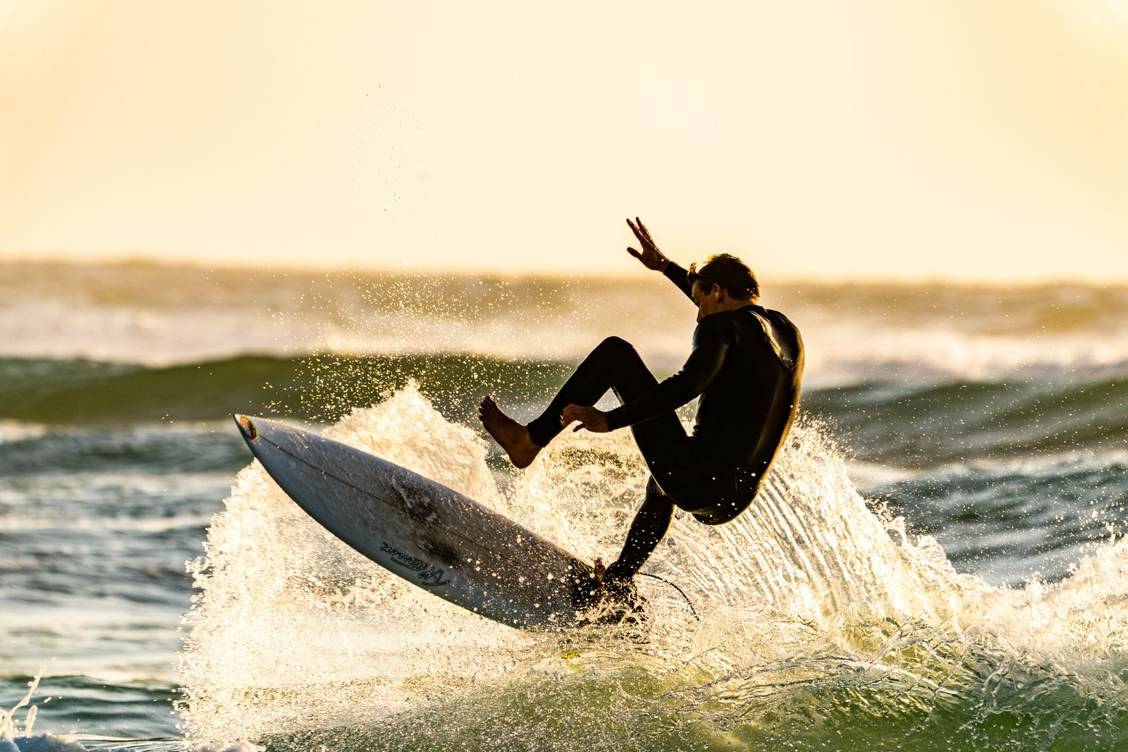Arugam Bay surfing - surfer riding a wave at sunrise