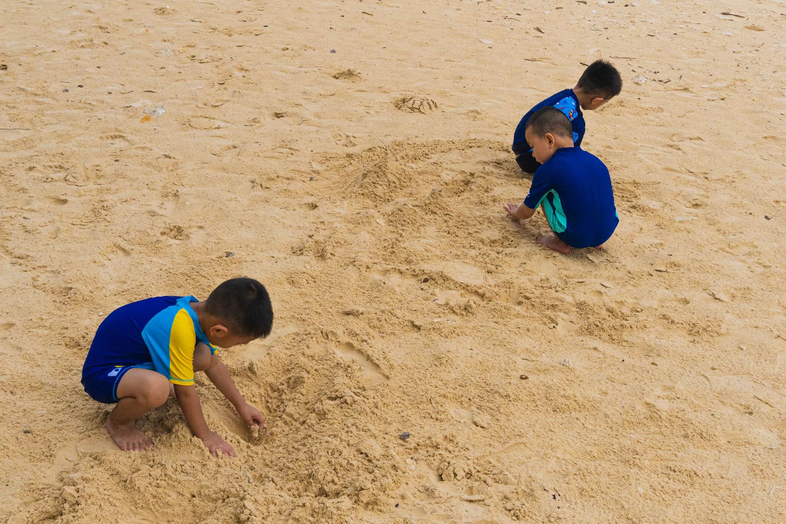 Sri Lanka family holiday packages - children digging and laughing on a south coast beach