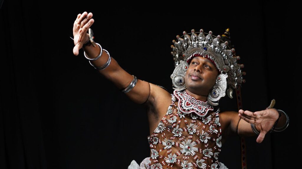 Kandyan dancers and drummers - a Kandyan ves dancer in a silver headdress at the Kandy Perahera