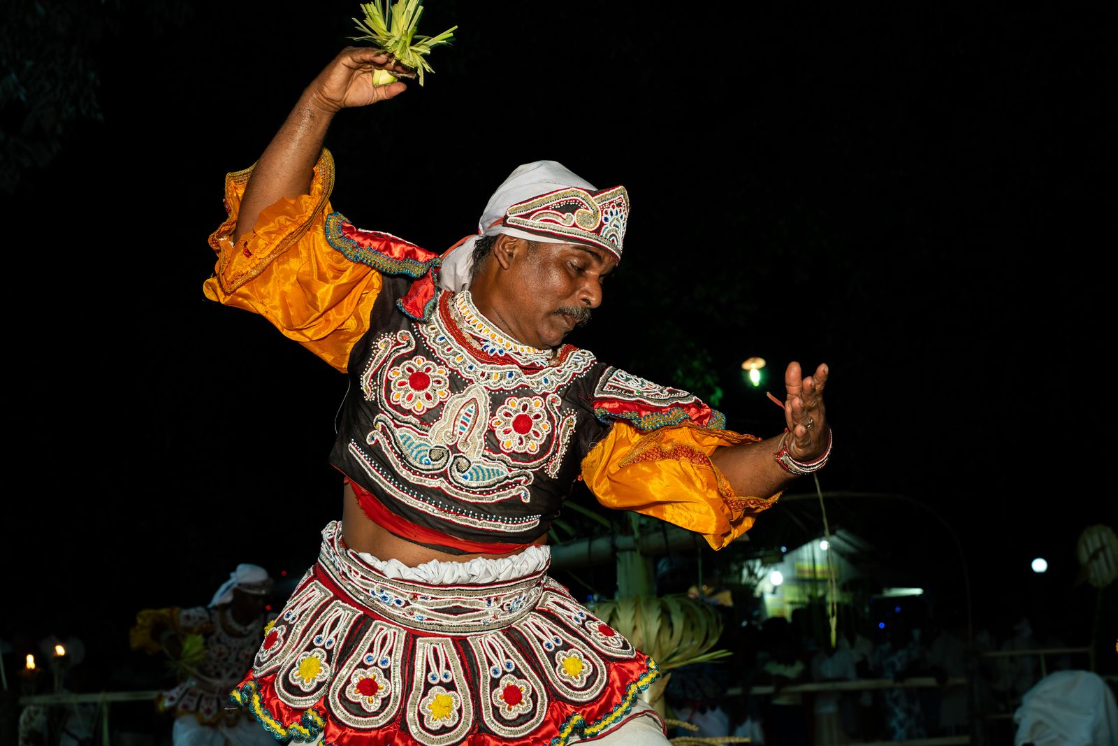 Kandy Esala Perahera 2026 - a Kandyan dancer performing at night during the Kandy Esala Perahera