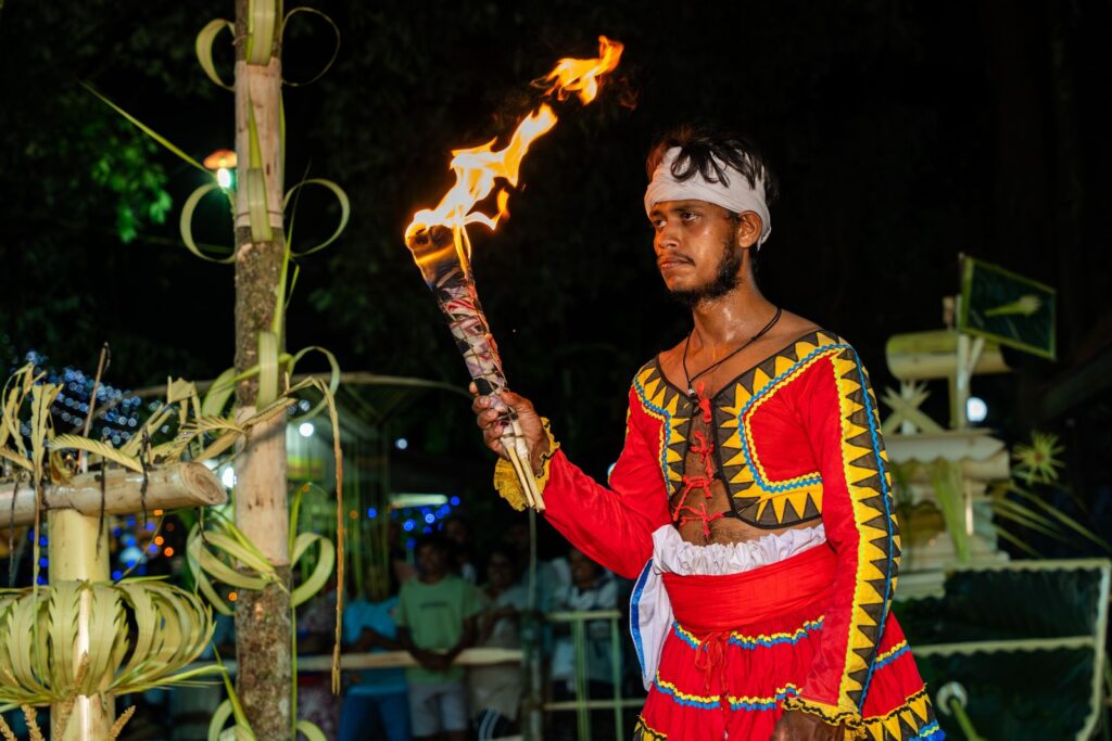 Esala Perahera elephants - a Sri Lankan fire dancer lighting the Perahera route in Kandy at night